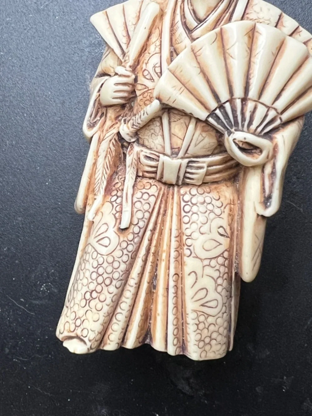Hand-carved Japanese figurine likely a samurai or similar figure